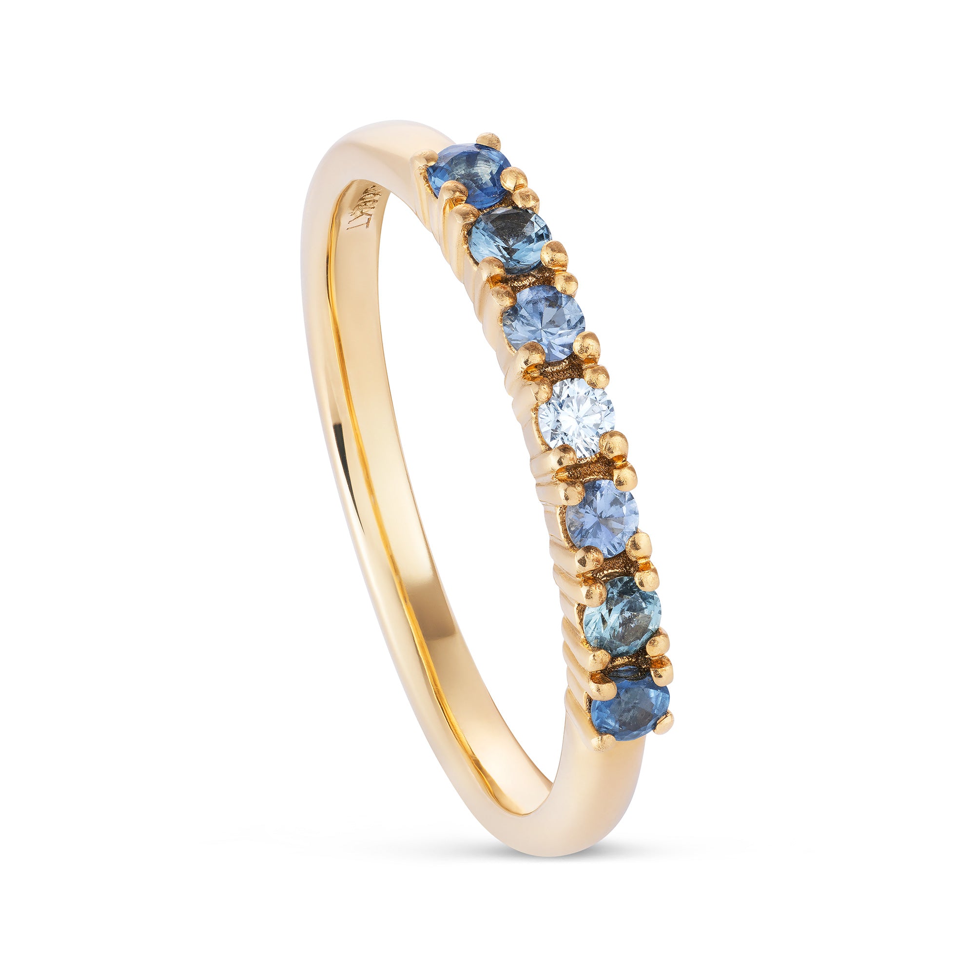 Yellow gold ring with seven small round stones, diamond in the centre, going out to light, mid and dark sapphires. Angled view.